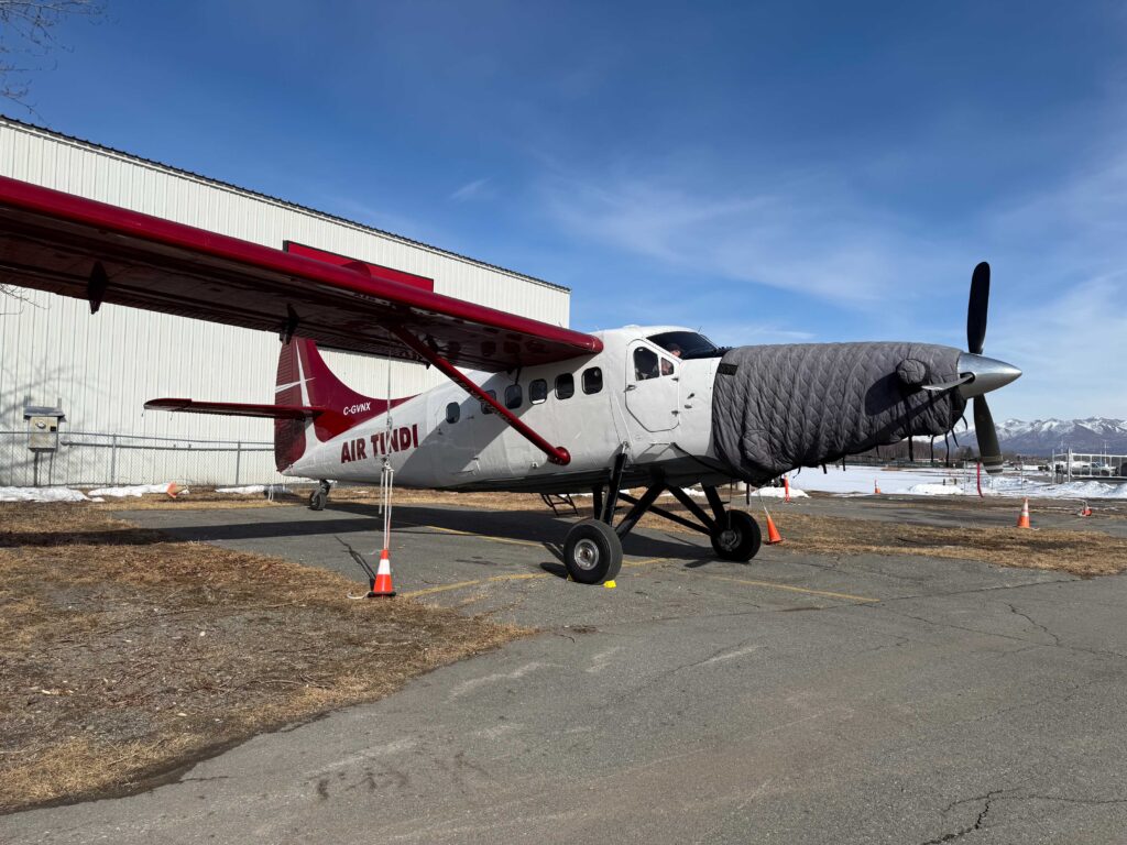 De Havilland Otter parked outside a hangar at Rust's Flying Service